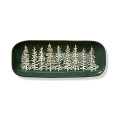 a green tray with white pine trees on it