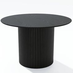 a black round table sitting on top of a white floor