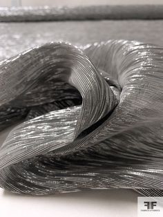 a close up view of an artistic object made out of silver foil and metal strips