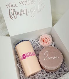 an open box containing two personal items and a card that says, will you be my flower girl?