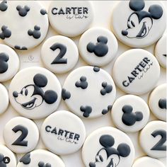 mickey mouse cookies with the numbers two and three for each one on them, all decorated in black and white