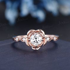 a rose shaped diamond ring on top of a table