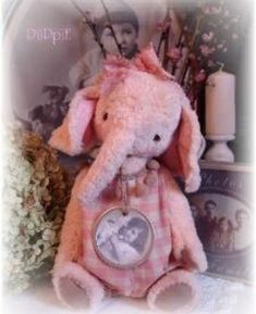 a pink stuffed animal sitting on top of a table