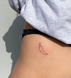 a small tattoo on the side of a woman's stomach