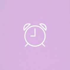 an alarm clock on a purple background with the letter l in it's center