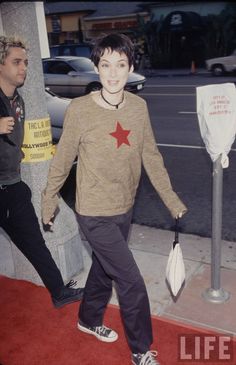 a young man is walking down the red carpet