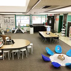 an empty classroom with tables and chairs in it