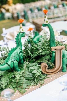 an instagram with two green dinosaur cake toppers