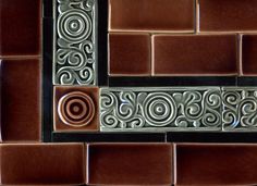 a close up view of a tile wall with decorative designs on the border and sides