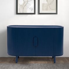 a blue cabinet with two pictures above it