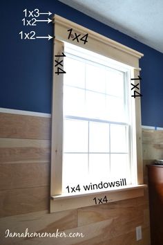 a window with measurements for the width of it in front of a blue painted wall