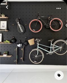 a bicycle mounted to a pegboard on a wall