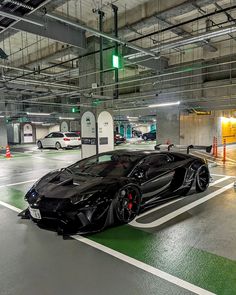 a black sports car parked in a parking garage