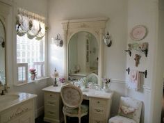 a bathroom with a vanity, mirror and chair in it's corner next to a window