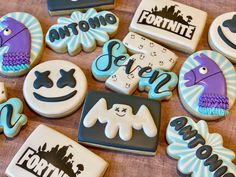 some decorated cookies sitting on top of a wooden table next to each other and the words fortnite