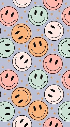 many different colored smiley faces on a blue background