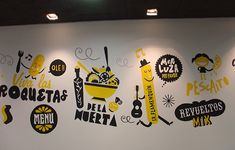 the wall is decorated with various logos and designs for mexican food restaurant, or restarauntry