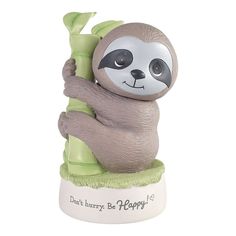 a ceramic figurine of a slotty holding a bamboo stalk with the words don't hurry be happy on it