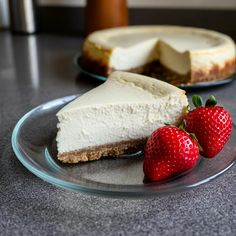 two slices of cheesecake on a plate with strawberries