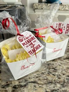 two bags of food sitting on top of a counter