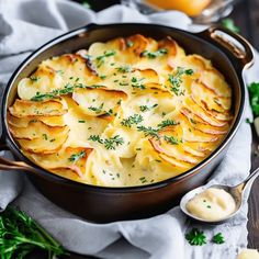 a casserole dish with potatoes and parsley