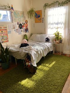 a bedroom with green carpet and white walls