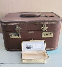 "Vintage Train Case! Brown leather travel bag Gold brass kisslock Rustic condition mirror  Vinyl cove interior  KEYS attached to the handle  Hard shell case with hard handle top    Good vintage lightly used condition,  some marks and normal wear. Measurements:  W:13\"   H:7.5\"   D:9\"" Brown Rectangular Travel Case, Rectangular Cases With Luggage Sleeve For Storage, Brown Rectangular Cases For Trip, Rectangular Brown Cases For Trip, Brown Rectangular Cases For Trips, Brown Rectangular Portable Case, Retro Rectangular Cases With Luggage Sleeve, Classic Rectangular Cases For Overnight Trips, Classic Compact Travel Case