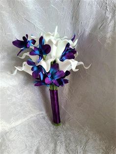 a purple and white bridal bouquet with orchids