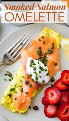 a plate with salmon, eggs and strawberries on it