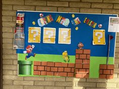 a bulletin board with mario's question marks on it and other items hanging from the wall