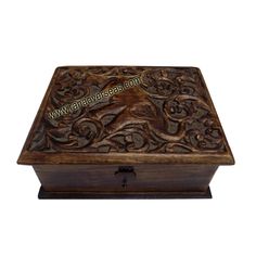 an ornate wooden box with carvings on it