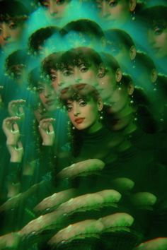 a group of people with their hands in front of them, all surrounded by green lights