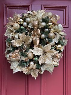 a wreath is hanging on the front door with christmas decorations and ornaments in gold, silver and green colors