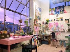 a room filled with lots of clutter next to a large window covered in pictures