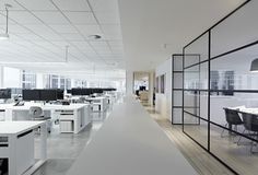 an empty office with desks and chairs