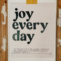 a piece of paper with the words joy every day written in black and yellow on it