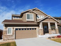 a large house with two garages in the front and one on the other side