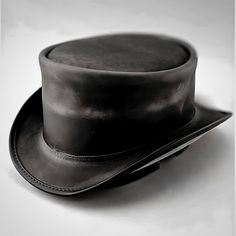 Meet the Ultimate Steampunk Top Hat, Your New Favorite Top Hat Searching for a hat that's more than just a stylish accessory? Our Men's Leather Top Hat in Midnight Black Suede is the perfect blend of vintage charm and Steampunk flair. Handcrafted with care, this hat isn't just about looking good--it's about making a statement. Note: Please read the full description and our policy below for an informed purchase. Why It Stands Out: Crafted for Quality: Every detail is meticulously designed with premium suede leather, ensuring durability and a luxurious feel. Shapeable Brim: Adjust the brim to your liking, offering both versatility in style and practical sun protection. Timeless Design: The unbanded style and classic proportions (2" brim, 3 3/4" crown) make it a go-to piece for any occasion-- Leather Top Hat, Steampunk Top, Steampunk Top Hat, Steampunk Hat, Black Leather Top, Gothic Victorian, Top Hats, Vintage Gothic, Mens Leather