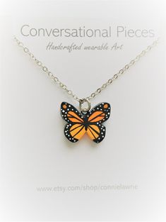 "This beautiful Monarch Butterfly pendant is made by hand using polymer clay. I then intricately paint each pendant to a striking Monarch Pattern. I've finished off this design using a dainty silver chain. This necklace looks pretty by itself, yet it also works great to be worn in layers with your other jewelry. This pendant measures just over 1/2 inch and is painted in detail on both sides! I do offer a variety of chain lengths. I love the beauty of the Monarch. This necklace will add a pop of Nickel-free Resin Pendant Jewelry, Adjustable Enamel Necklace For Gifts, Nickel-free Silver Resin Jewelry, Silver Enamel Jewelry With Adjustable Chain, Hand Painted Pendant Necklaces In Sterling Silver, Handmade Orange Resin Necklace, Yellow Resin Jewelry As Gift, Hand Painted Sterling Silver Pendant Necklace, Yellow Resin Jewelry For Gifts