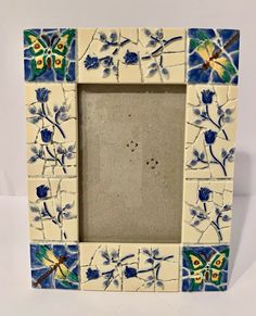 a white frame with blue and green flowers on it