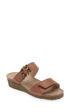 A rounded buckle stands out at the strap of a summery sandal set on a walkable wedge for everyday comfort and style. 1 1/4" heel (size 39) Adjustable hook-and-loop straps Cushioned footbed with arch support Leather upper and lining/synthetic sole Imported Leather Wedge Heel Sandals For Everyday, Classic Brown Footbed Sandals For Summer, Everyday Brown Toe Loop Sandals, Classic Brown Footbed Sandals For Spring, Spring Brown Footbed Sandals With Heel Loop, Brown Leather Footbed Sandals For Everyday, Leather Open Toe Wedge Sandals For Everyday, Everyday Brown Leather Footbed Sandals, Leather Open Toe Wedge Sandals