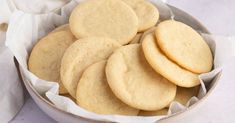 a white bowl filled with cookies on top of a table