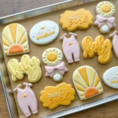 baby shower cookies are arranged on a cookie sheet