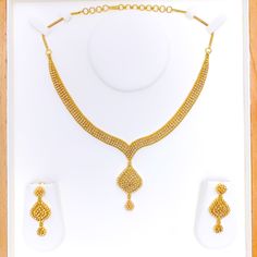 The Glistening Upscale 22k Gold Kundan Necklace Set, weighing 58.9 grams, is a symbol of luxurious elegance. Crafted with 22k gold, it boasts a luminous yellow gold finish that perfectly accentuates the richly set Kundan stones. The necklace is 16 inches long, featuring a 1.75-inch drop and 1.8-inch adjustable links for a tailored fit. A secure hook lock ensures ease of wear. Complementing the set are matching earrings, each 1.75 inches in length, with screw-back posts for secure fitting. Ideal Gold Bridal Necklace As A Gift, 22k Yellow Gold Jewelry For Diwali, 22k Yellow Gold Bridal Necklace For Festivals, 22k Yellow Gold Bridal Necklace For Diwali, Gold-plated Temple Necklace With Elegant Design, 22k Yellow Gold Kundan Necklace As Gift, 22k Gold Kundan Necklace For Diwali And Formal Occasions, 22k Gold Necklaces For Celebration With Elegant Design, 22k Gold Necklaces With Elegant Design For Celebration