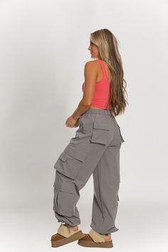 NEW Limited Edition & custom designed Dusty Grey Parachute Pants! Not only did we spend months designing these amazing cargo style pants, but we PERFECTED them in the process! These pants are insanely versatile due to their lightweight material and trendy style. They feature adjustable ankle cuffs that you can leave wide or tie up for a jogger look. The elastic waist-band allows for a comfortable fit and the multiple pockets provide great functionality. These pants easily can be worn for any wor Techwear High-waisted Cargo Pants, Loosely Fitted Parachute Pants With Cargo Pockets, Loosely Fitted High-waisted Cargo Pants, Loosely Fitted Wide-leg Cargo Pants With Multiple Pockets, Trendy Full-length Parachute Pants With Multiple Pockets, Trendy Full Length Parachute Pants With Multiple Pockets, Trendy Parachute Pants With Multiple Pockets And Loose Fit, Grey Parachute Pants, Cargo Style