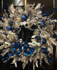 a wreath with blue and silver decorations on it