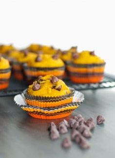 chocolate chip pumpkin muffins on a cooling rack with more muffins in the background