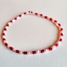 This bracelet is the perfect accessory for those who like to wear their heart on their sleeve! Featuring a blend of pink, red, and white seed beads, the Peppermint Hearts Stretch Bracelet looks sweet and stylish. Add a touch of whimsy to your look! Seed Bead Bracelet Ideas, Bead Bracelet Ideas, Seed Bead Bracelet, Bracelet Ideas, Heart On, Bracelet Patterns, Stretch Bracelet