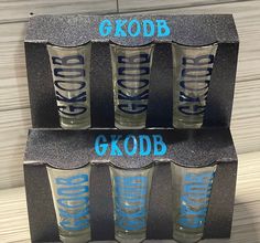 four shot glasses with the words g kodb and g k odb on them