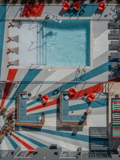 an overhead view of a swimming pool with red, white and blue stripes on it